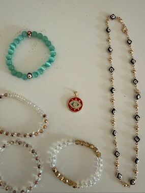 Various Evil Eye jewelry pieces: Pendant, Necklace, bracelets.